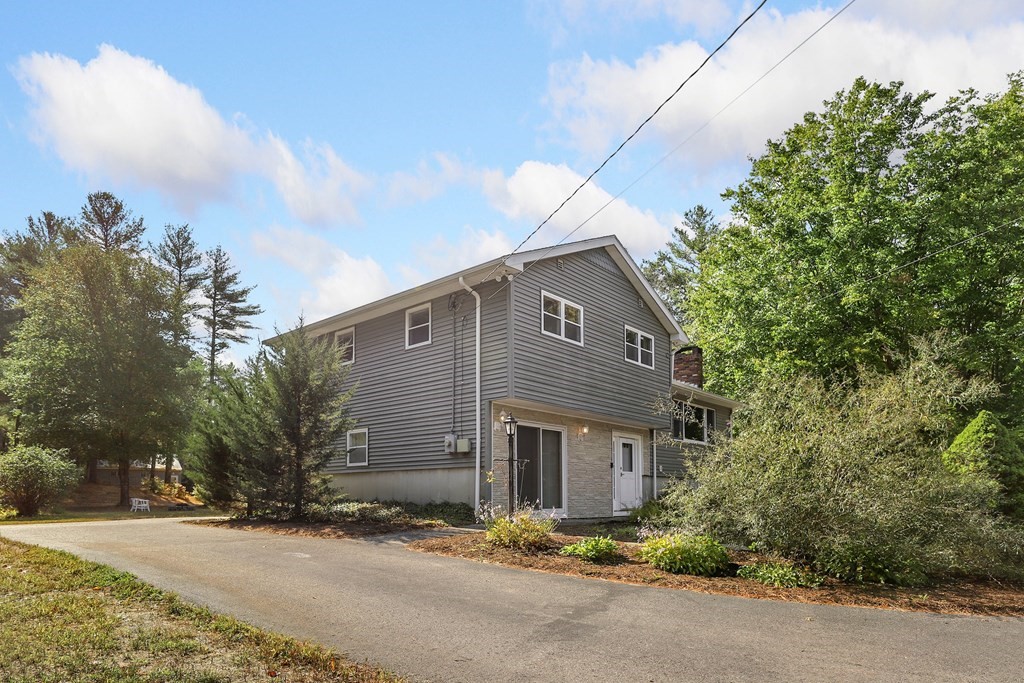 75 Chipaway Road Freetown, MA 02717 - Photo 4 of 34 a front view of a house with a yard and garage