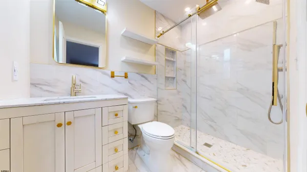 a bathroom with a toilet and a shower
