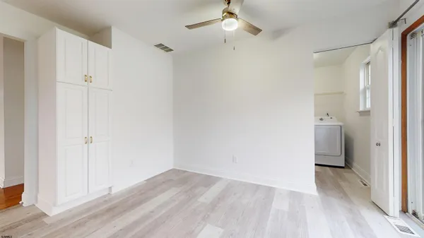 a view of room with hardwood floor and closet area