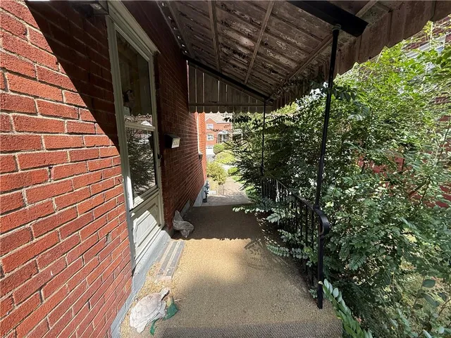 a view of a pathway of a building with wooden walls