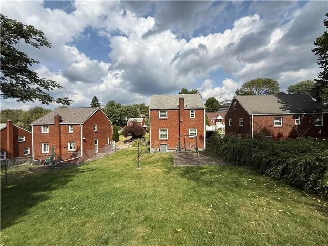aerial view of a house with a big yard and a fountain