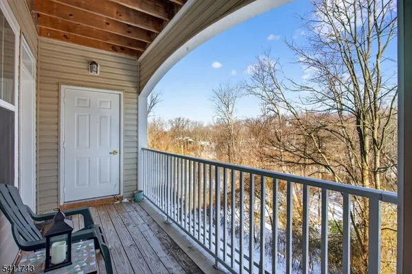 a view of balcony with wooden floor and fence