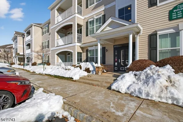 a view of a building with a yard covered in snow
