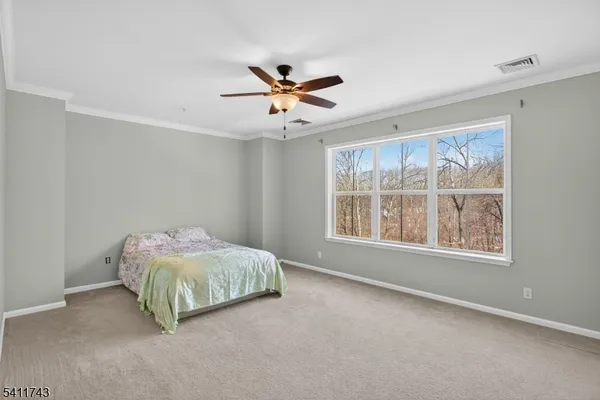 a living room with a bed and a window