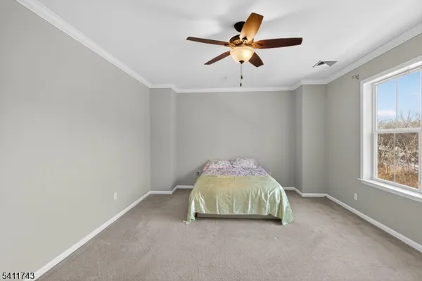 a room with a ceiling fan and a window