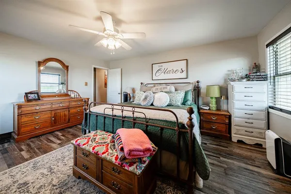 a bedroom with furniture and wooden floor