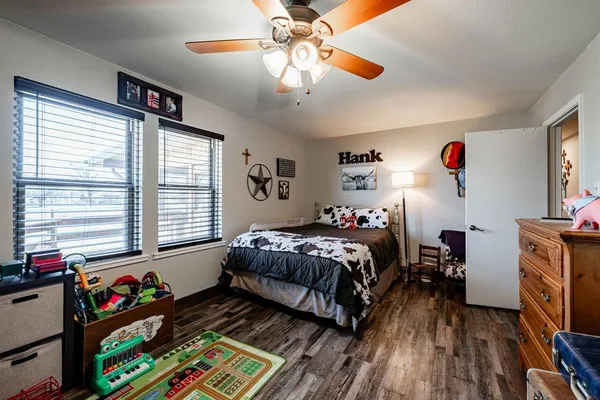 a bedroom with bed and a large window