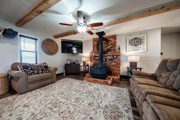 a living room with furniture a fireplace and a window
