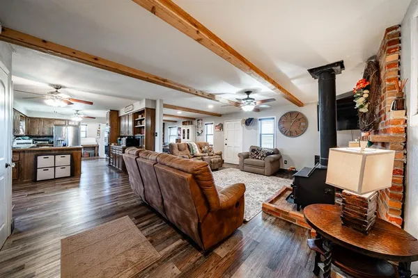 a living room with furniture and wooden floor