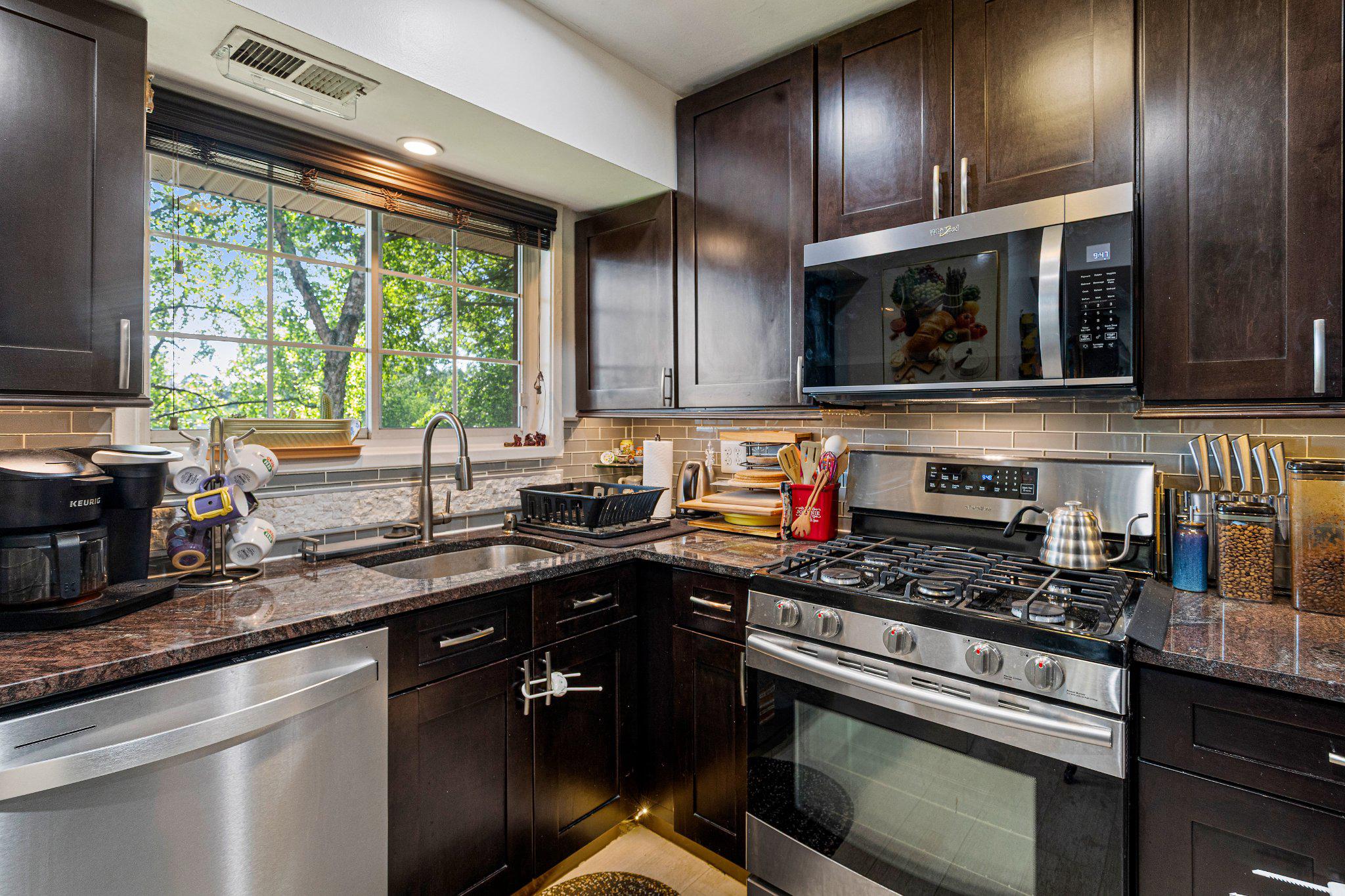 5613 Franconia Road, Unit 303 Alexandria, VA 22310 - Photo 12 of 27 a kitchen with granite countertop stainless steel appliances a sink stove and cabinets