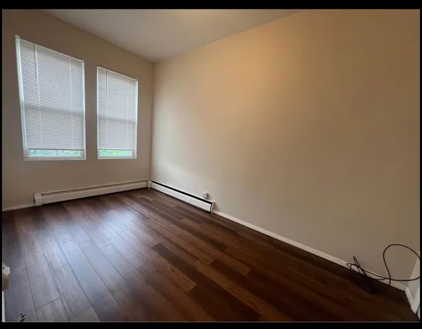 a view of wooden floor and windows in a room