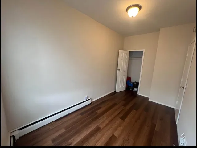 an empty room with wooden floor