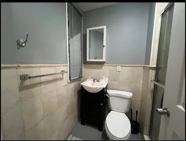 a bathroom with a toilet sink and mirror