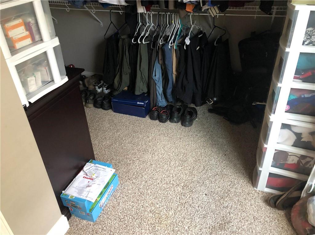 37 Farmstead Way Senoia, GA 30276 - Photo 12 of 96 a view of walk in closet with clothes and shoes
