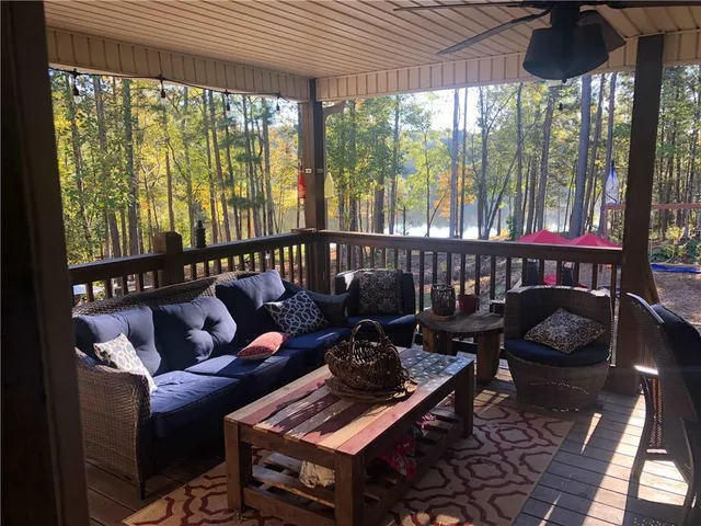 a living room with furniture and a floor to ceiling window