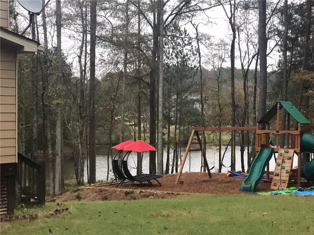a view of staircase with lots of frames on wall and wooden floor