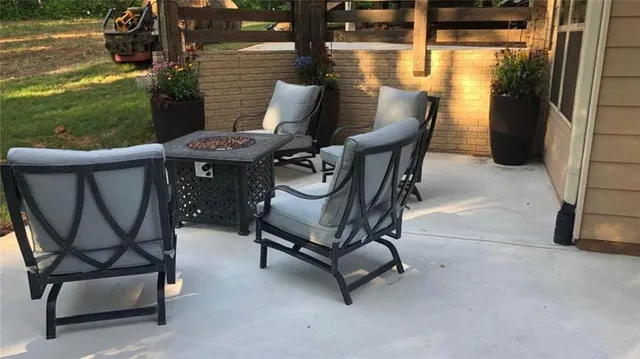 a living room with furniture a ceiling fan and a rug
