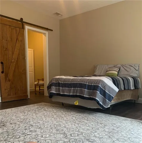 a view of a hallway with wooden floor and entryway