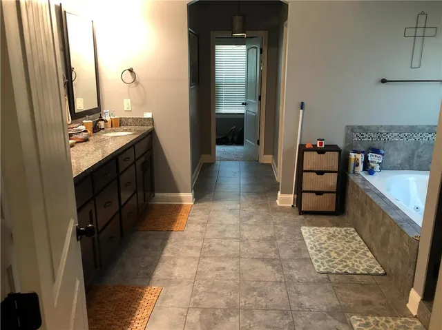 a view of a house door with a potted plant front of house
