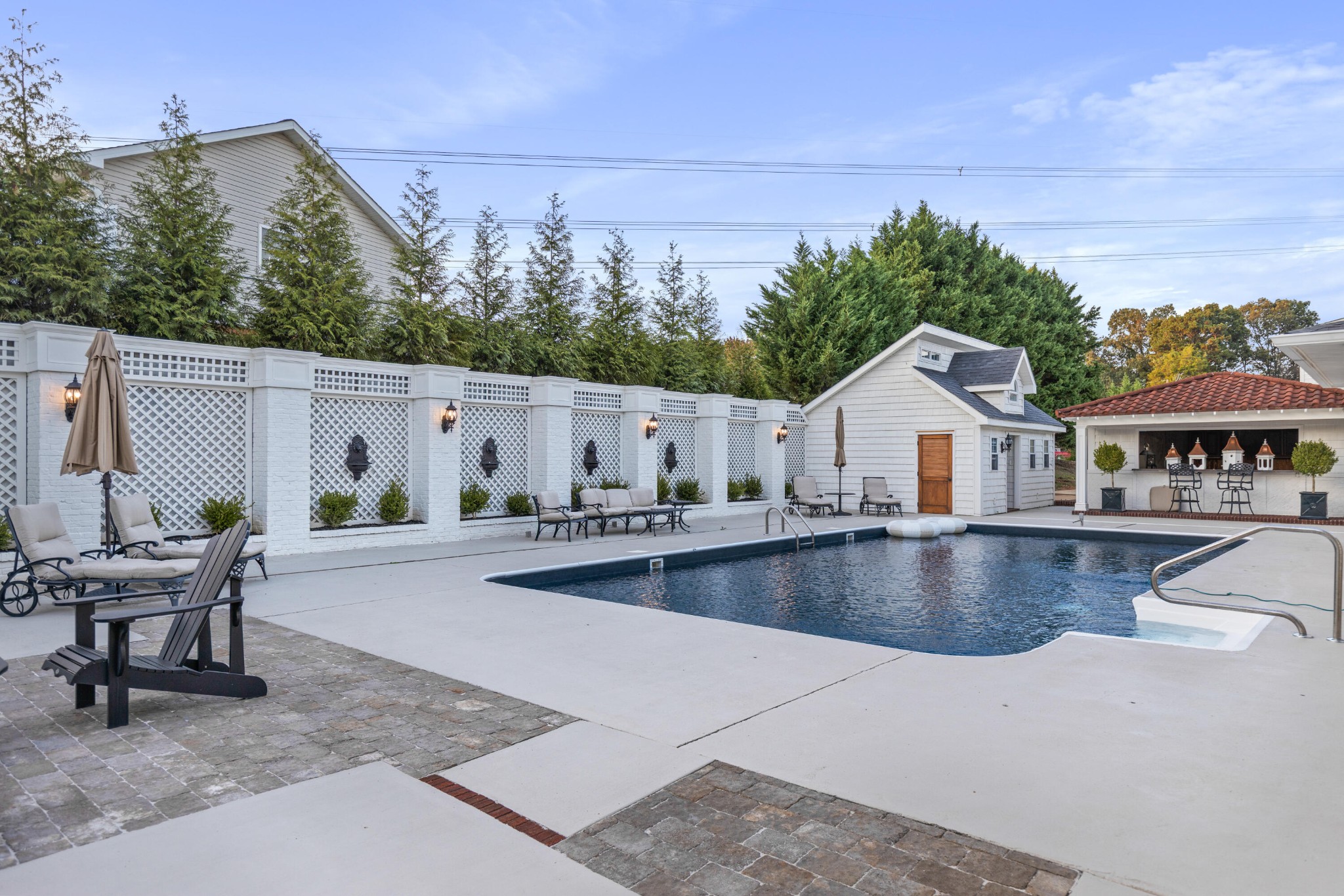 8421 Pedigo Road Powell, TN 37849 - Photo 42 of 57 a view of swimming pool with outdoor seating and house in the background