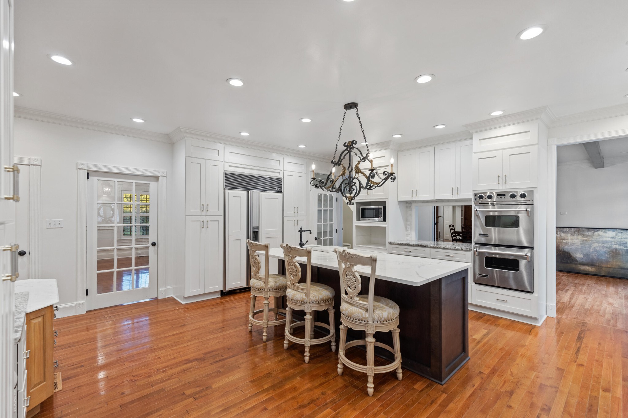 8421 Pedigo Road Powell, TN 37849 - Photo 9 of 57 a large kitchen with dining table wooden floor and stainless steel appliances