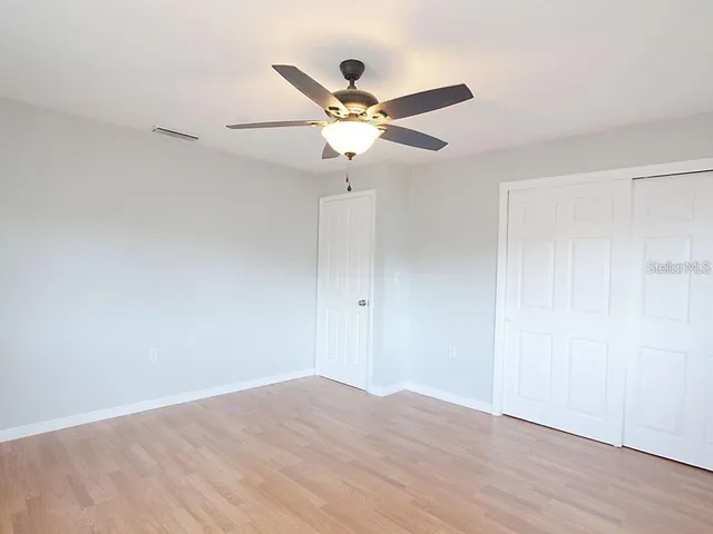 a view of a ceiling fan with wooden floor