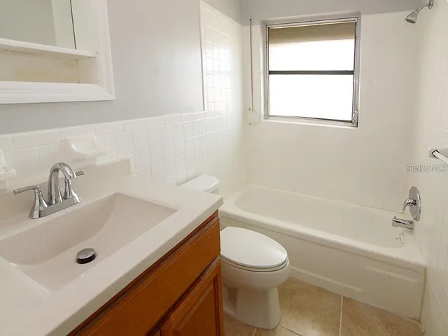 a bathroom with a sink a toilet and bathtub