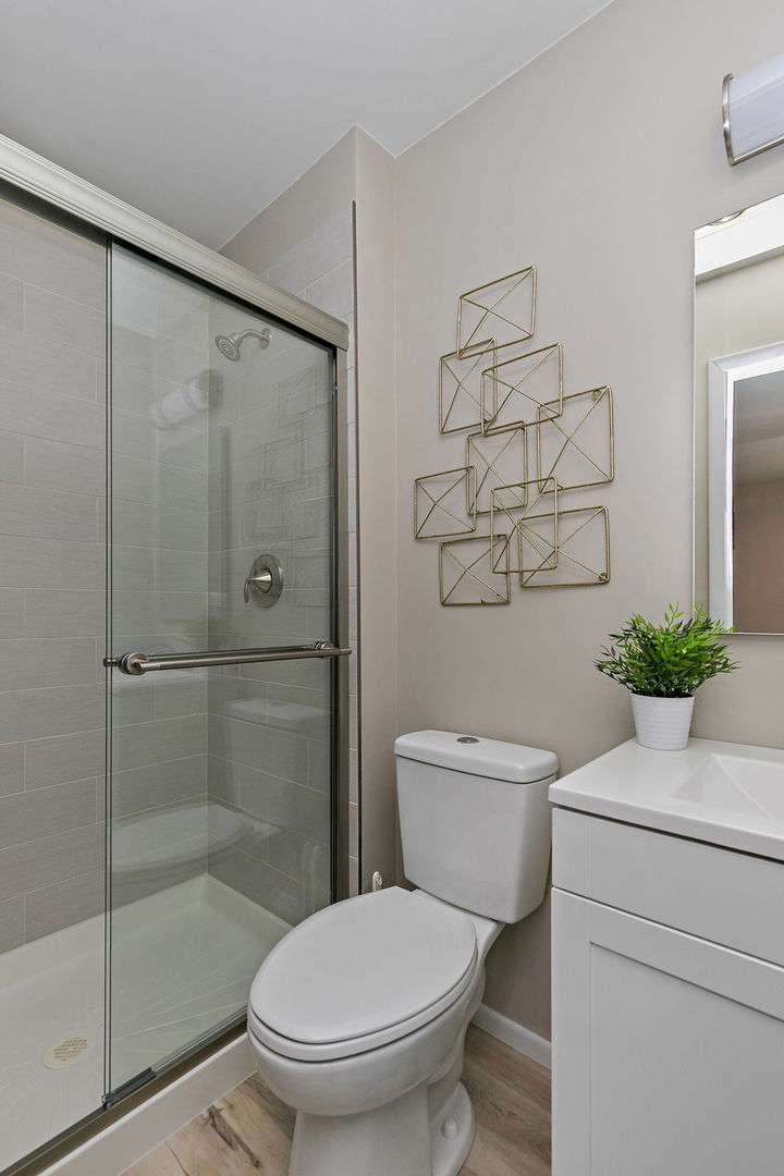 218 Deerpath Court, Unit B2 Schaumburg, IL 60193 - Photo 18 of 21 a bathroom with a toilet and a shower