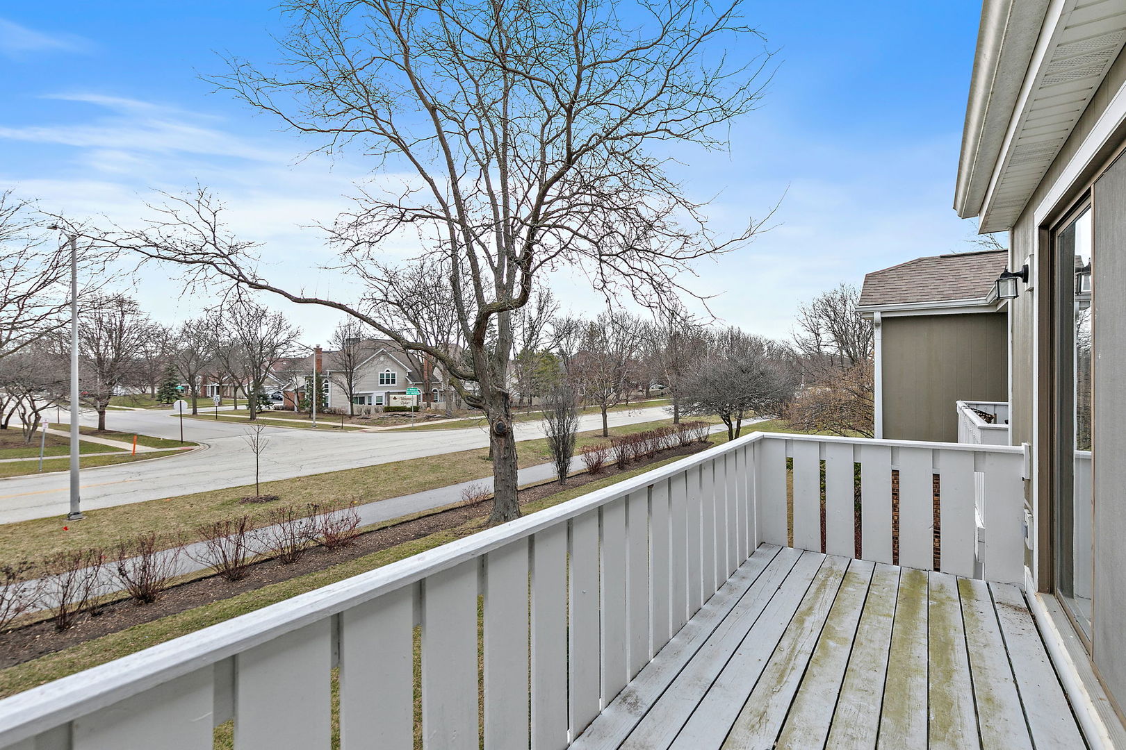 218 Deerpath Court, Unit B2 Schaumburg, IL 60193 - Photo 19 of 21 a view of balcony with wooden floor and fence