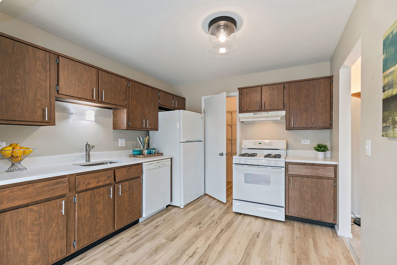 218 Deerpath Court, Unit B2 Schaumburg, IL 60193 - Photo 9 of 21 a kitchen with a sink a refrigerator and cabinets