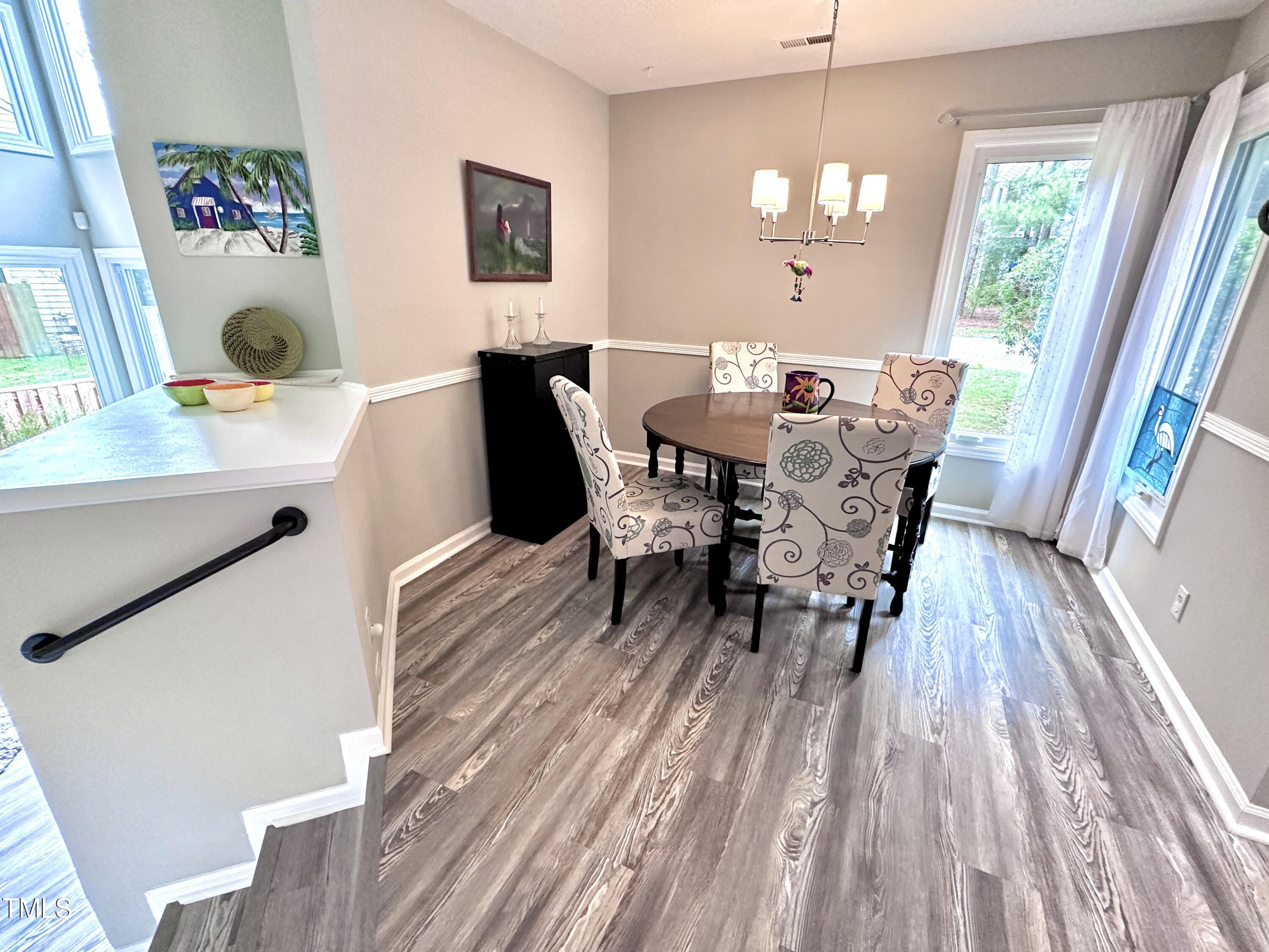 4311 Beechnut Lane Durham, NC 27707 - Photo 20 of 56 a view of a dining room with furniture and wooden floor