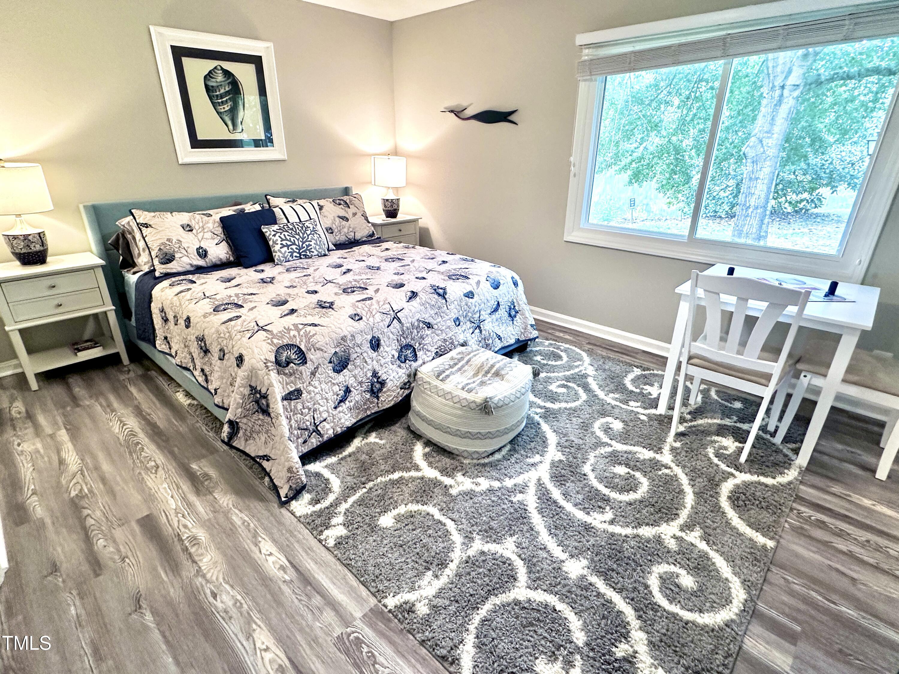 4311 Beechnut Lane Durham, NC 27707 - Photo 30 of 56 a bedroom with a bed and wooden floor