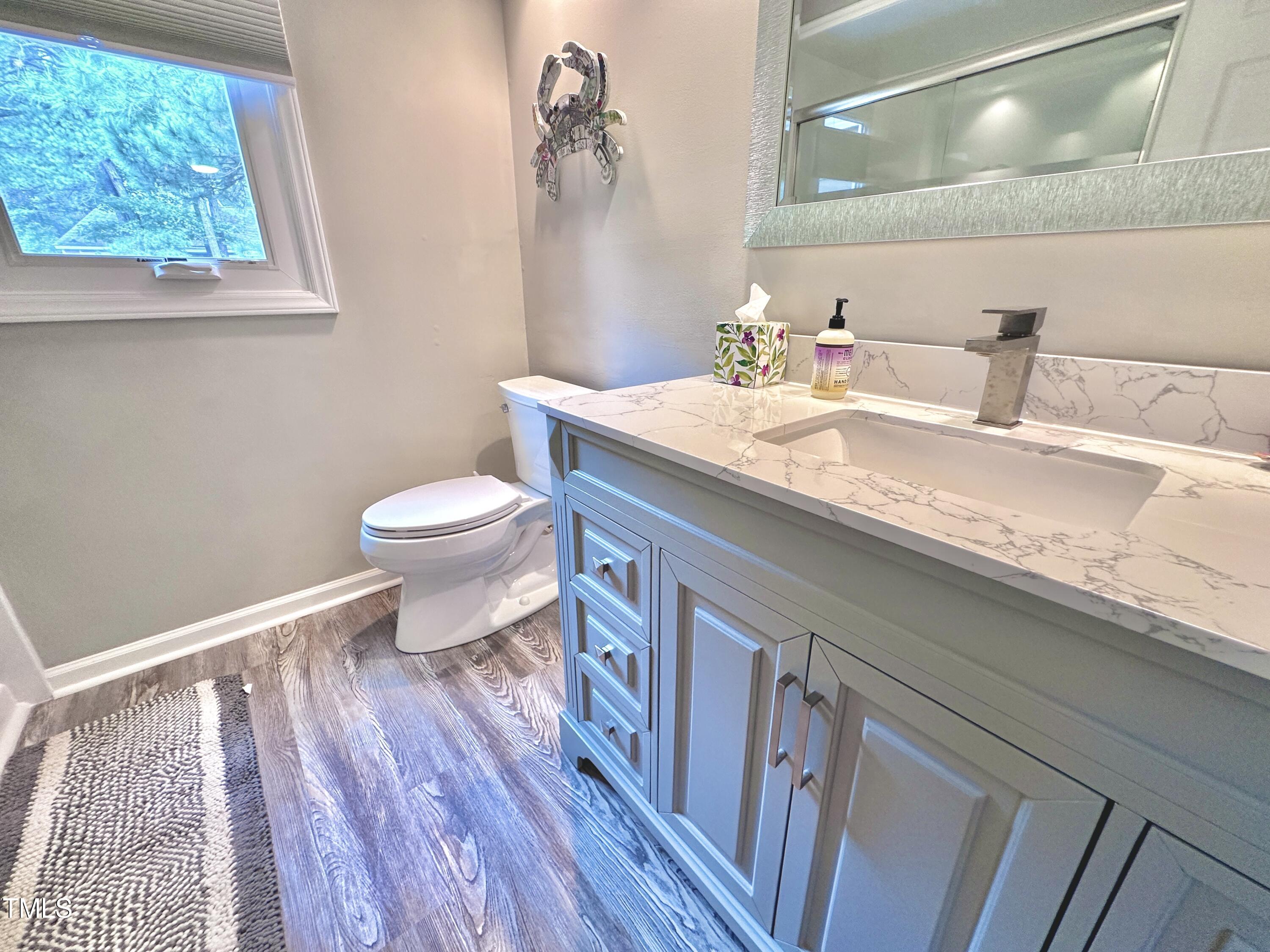 4311 Beechnut Lane Durham, NC 27707 - Photo 34 of 56 a bathroom with a granite countertop sink toilet and a mirror