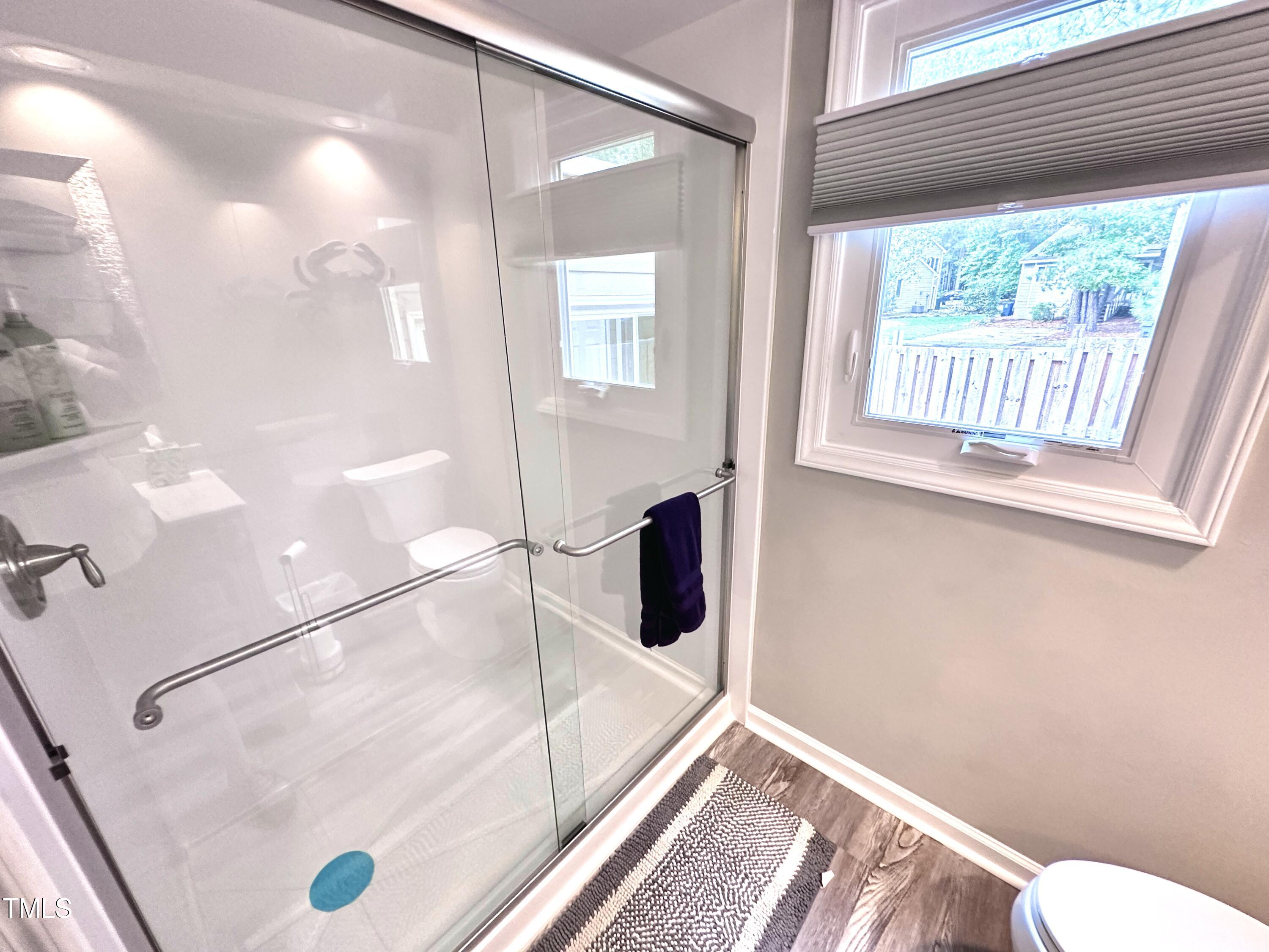 4311 Beechnut Lane Durham, NC 27707 - Photo 35 of 56 a bathroom with a bathtub and a shower