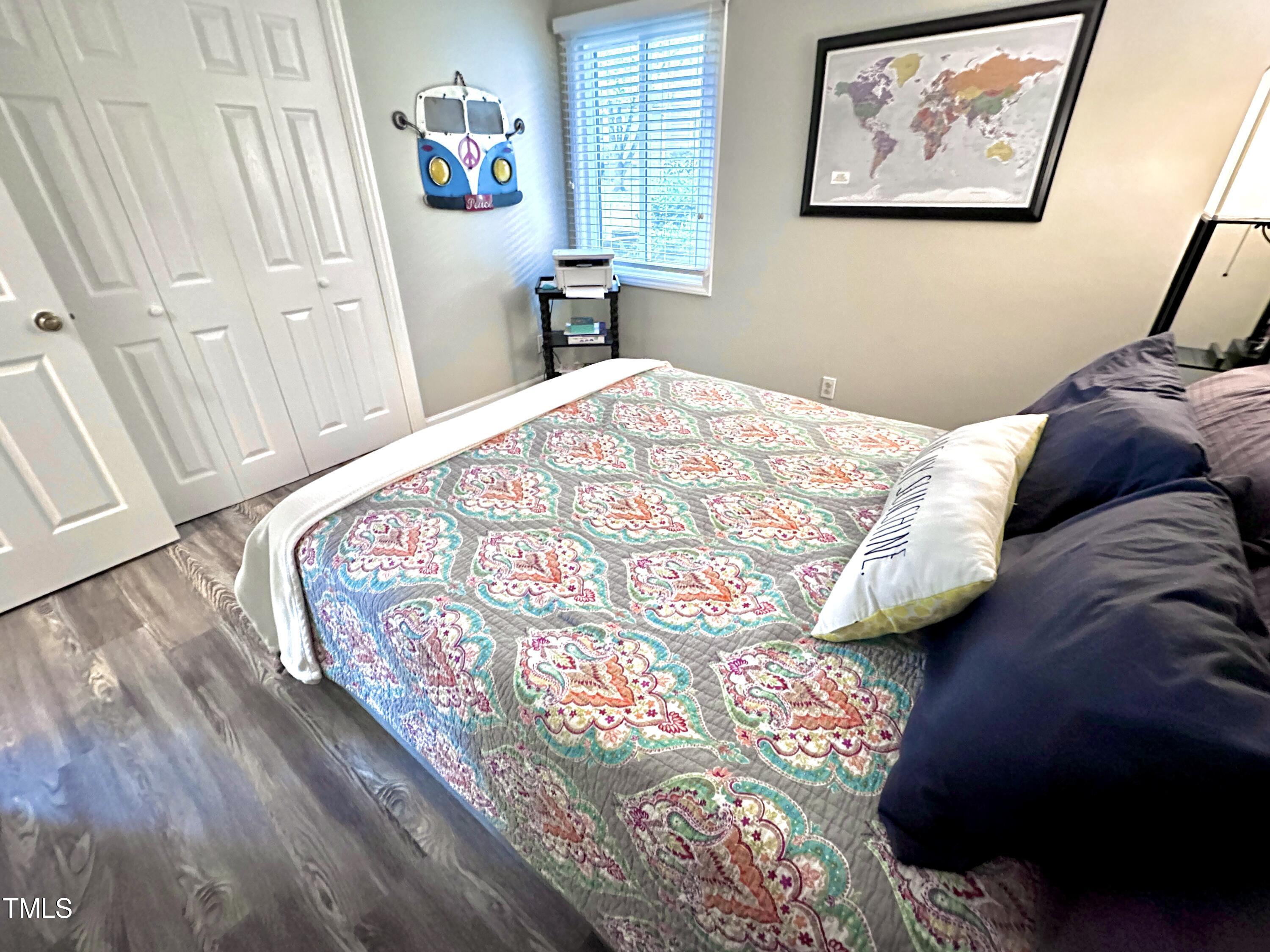 4311 Beechnut Lane Durham, NC 27707 - Photo 40 of 56 a bedroom with a bed and a painting on the wall