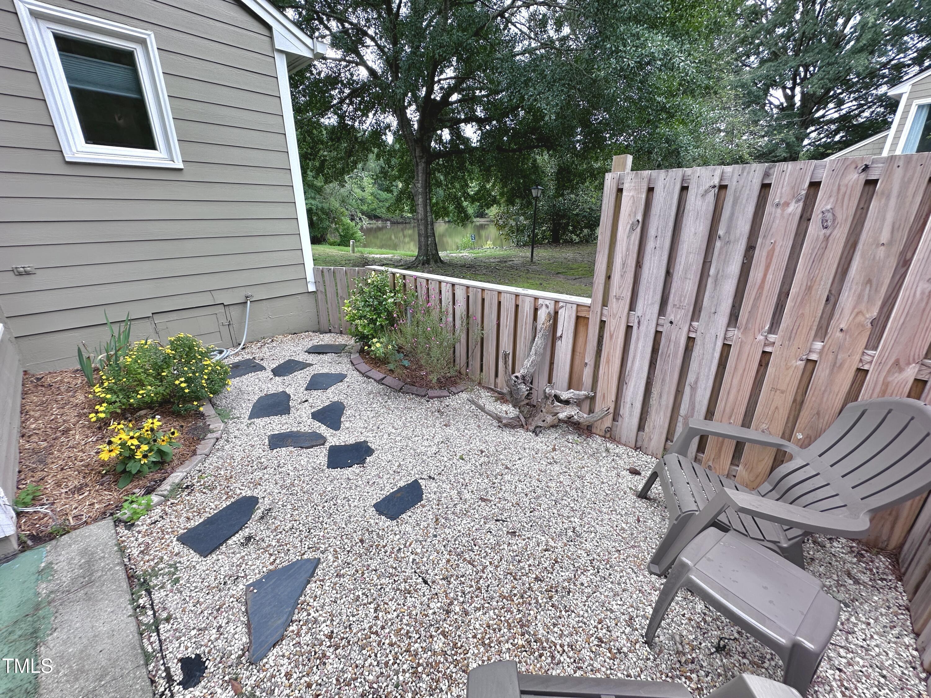 4311 Beechnut Lane Durham, NC 27707 - Photo 41 of 56 a view of a wooden door with a bench
