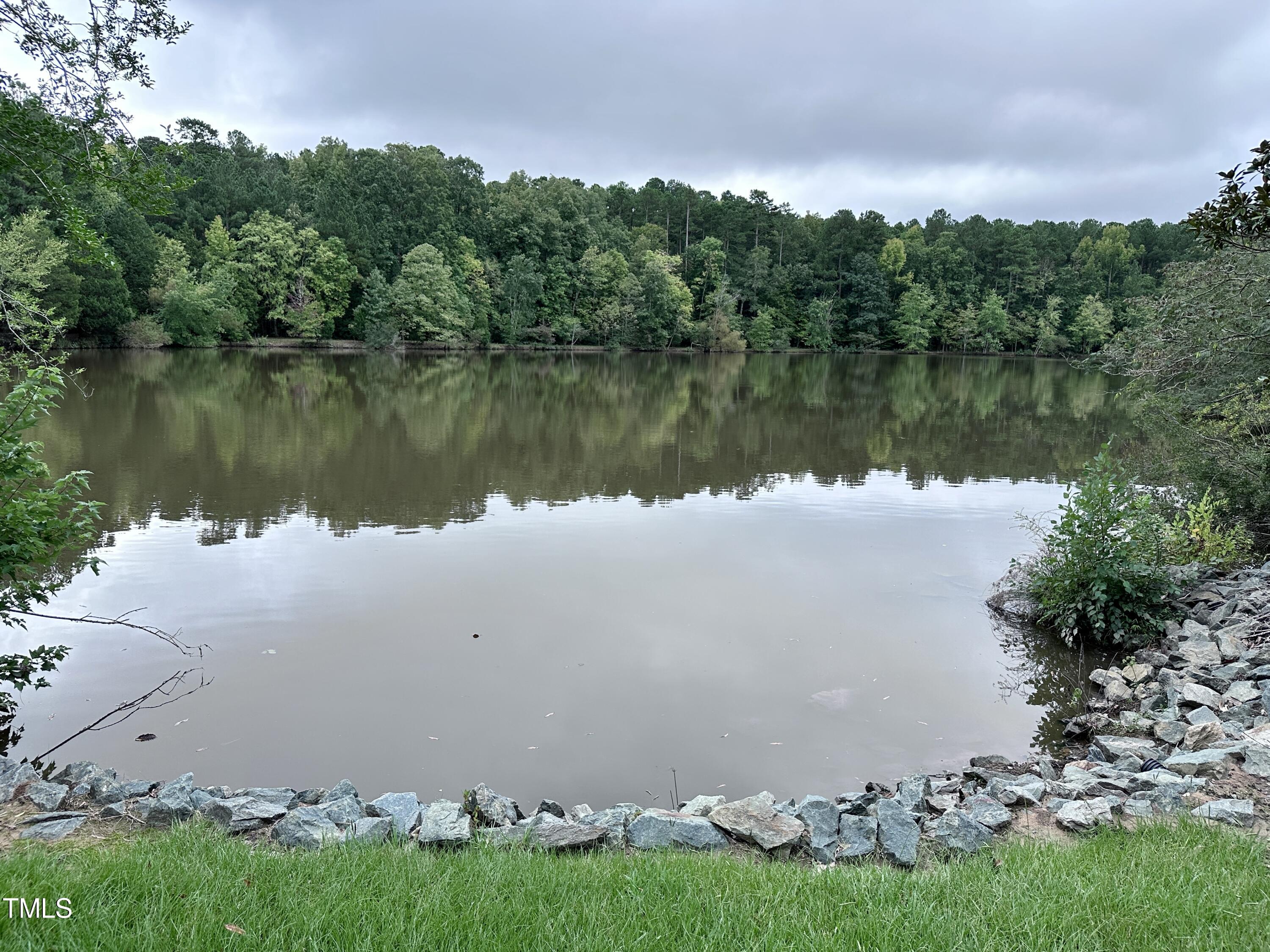 4311 Beechnut Lane Durham, NC 27707 - Photo 42 of 56 a view of a lake with houses in the back