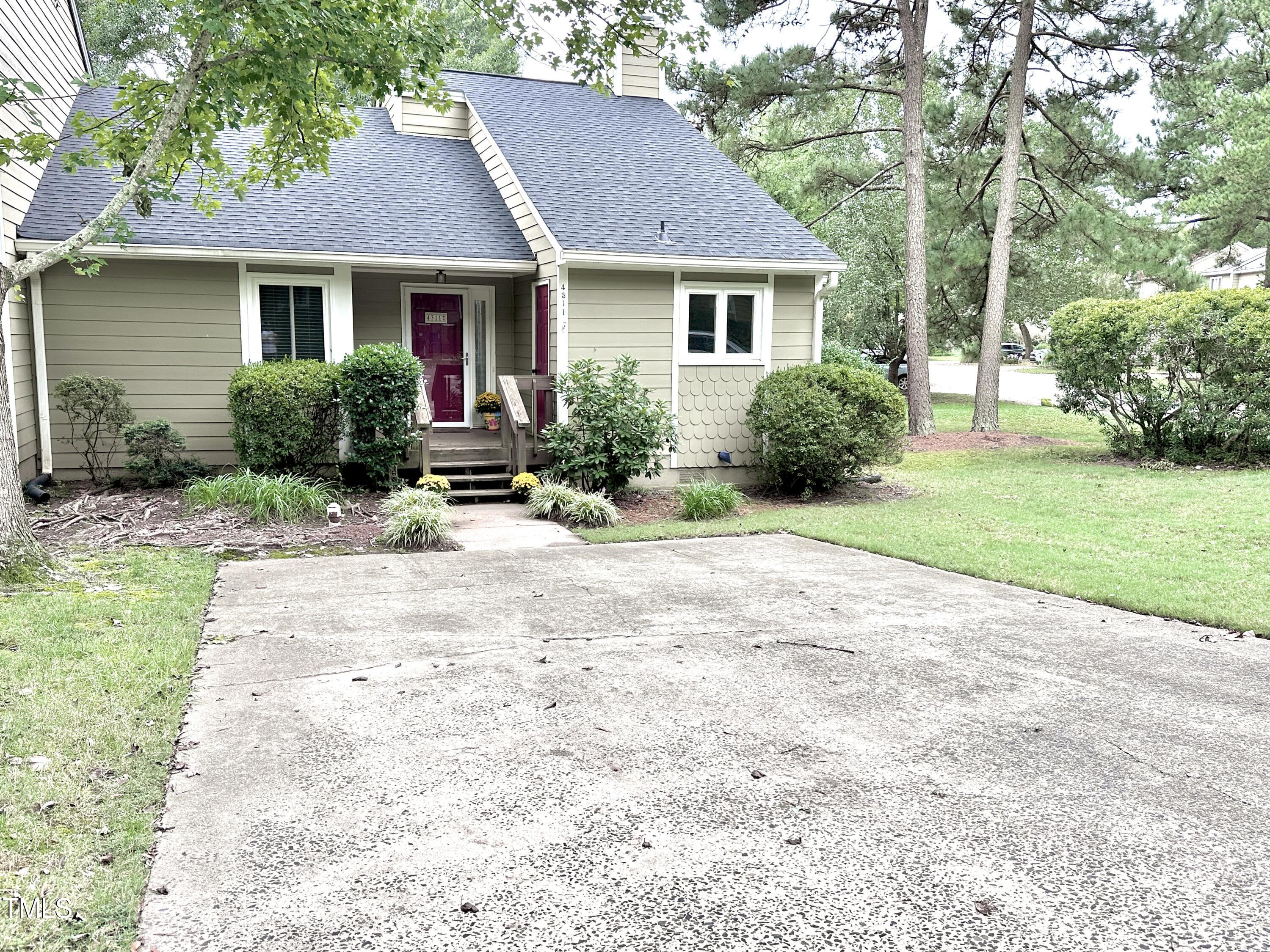 4311 Beechnut Lane Durham, NC 27707 - Photo 49 of 56 a front view of a house with a yard and potted plants
