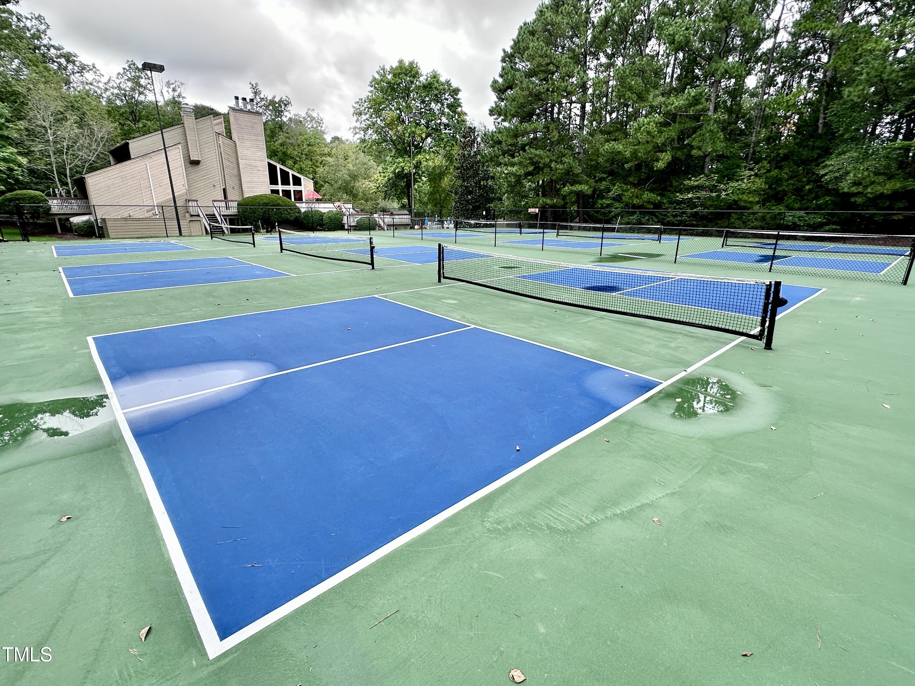 4311 Beechnut Lane Durham, NC 27707 - Photo 55 of 56 a view of a tennis ground with large trees