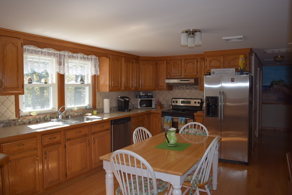 106 Williston Road Bourne, MA 02562 - Photo 4 of 9 a kitchen with granite countertop a sink a counter space appliances and cabinets