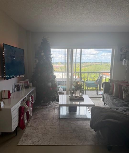 4164 Inverrary Drive, Unit 913 Lauderhill, FL 33319 - Photo 11 of 25 a living room with furniture and a flat screen tv