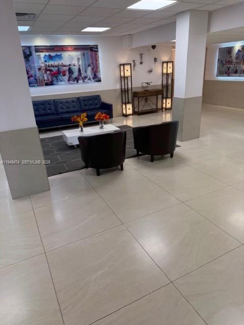 4164 Inverrary Drive, Unit 913 Lauderhill, FL 33319 - Photo 9 of 25 a living room with stainless steel appliances kitchen island granite countertop a sink and cabinets