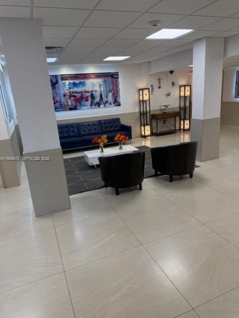 4164 Inverrary Drive, Unit 913 Lauderhill, FL 33319 - Photo 10 of 25 a living room with furniture and a kitchen view