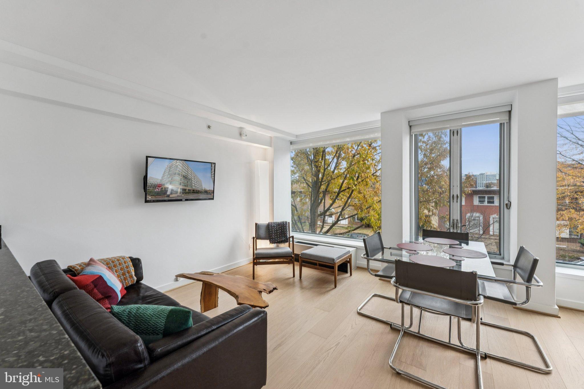 1101 3rd Street Southwest, Unit 114 Washington, DC 20024 - Photo 4 of 29 a living room with furniture and a large window