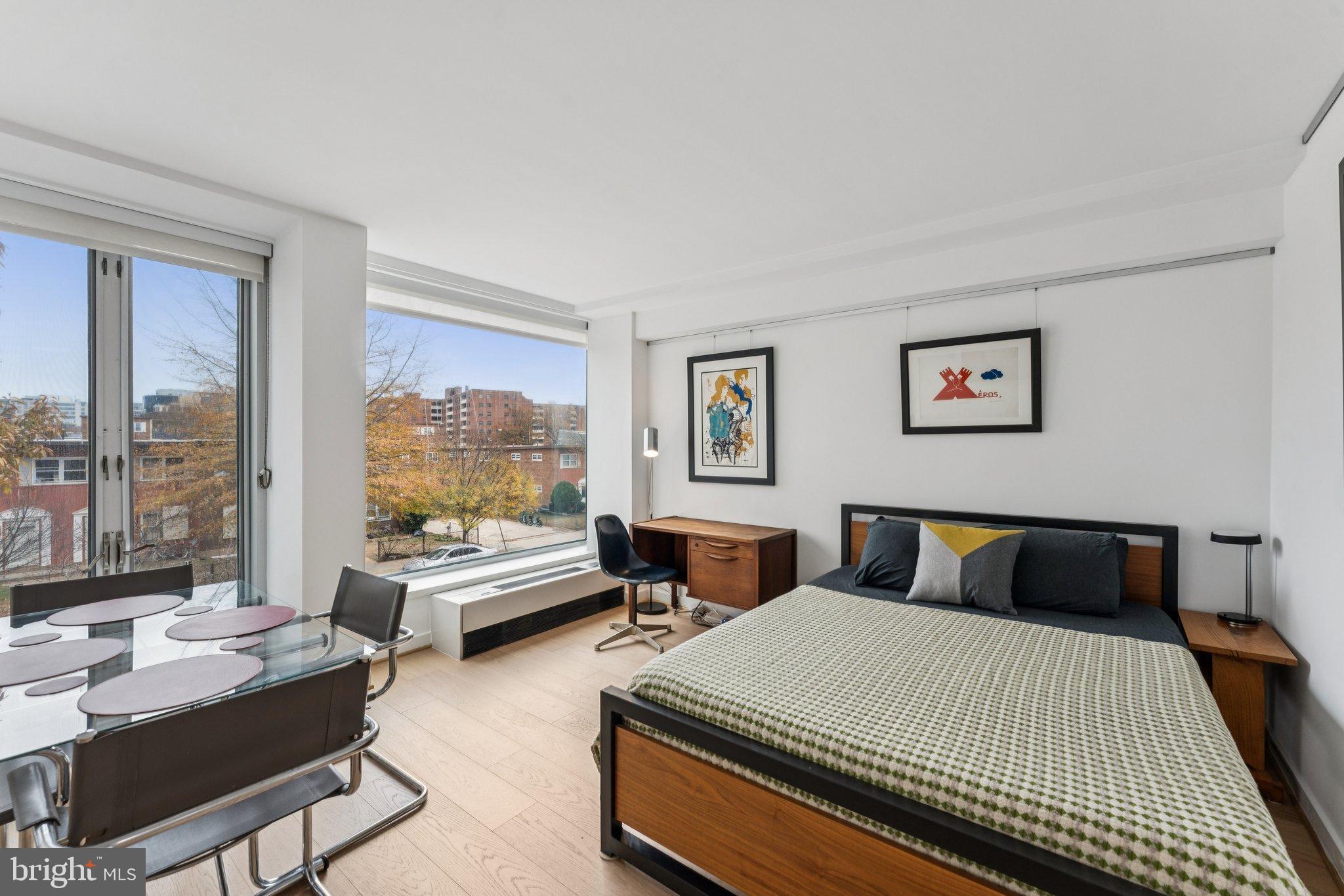 1101 3rd Street Southwest, Unit 114 Washington, DC 20024 - Photo 5 of 29 a bedroom with a large bed and a balcony