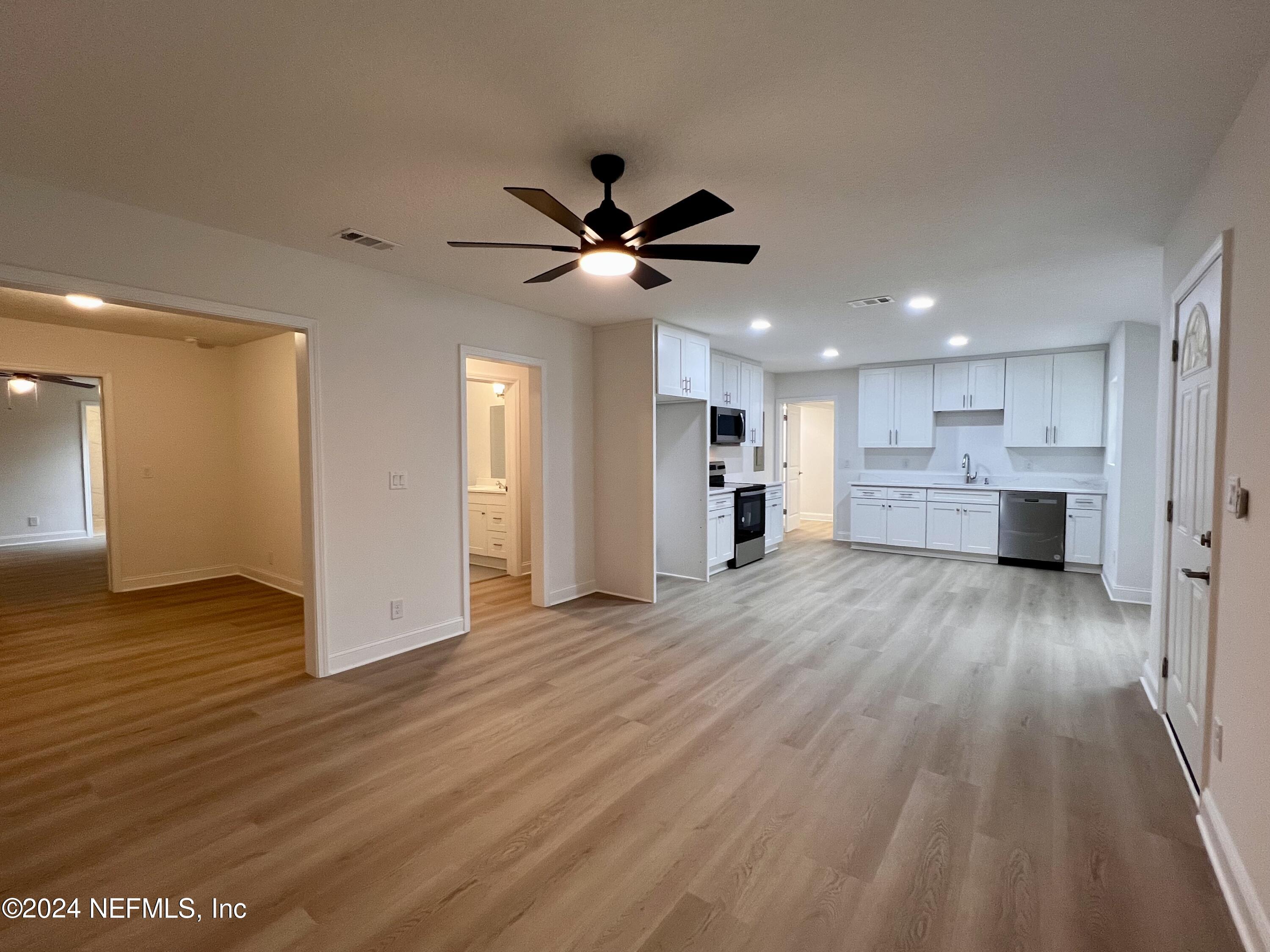 1833 Bartram Road Jacksonville, FL 32207 - Photo 11 of 50 a view of kitchen and empty room with wooden floor