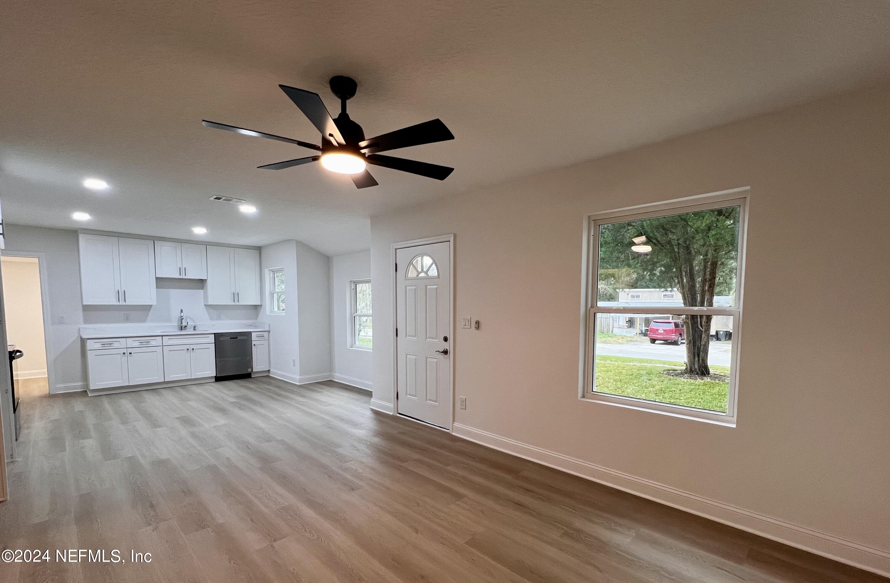 1833 Bartram Road Jacksonville, FL 32207 - Photo 12 of 50 a view of an empty room with window and wooden floor