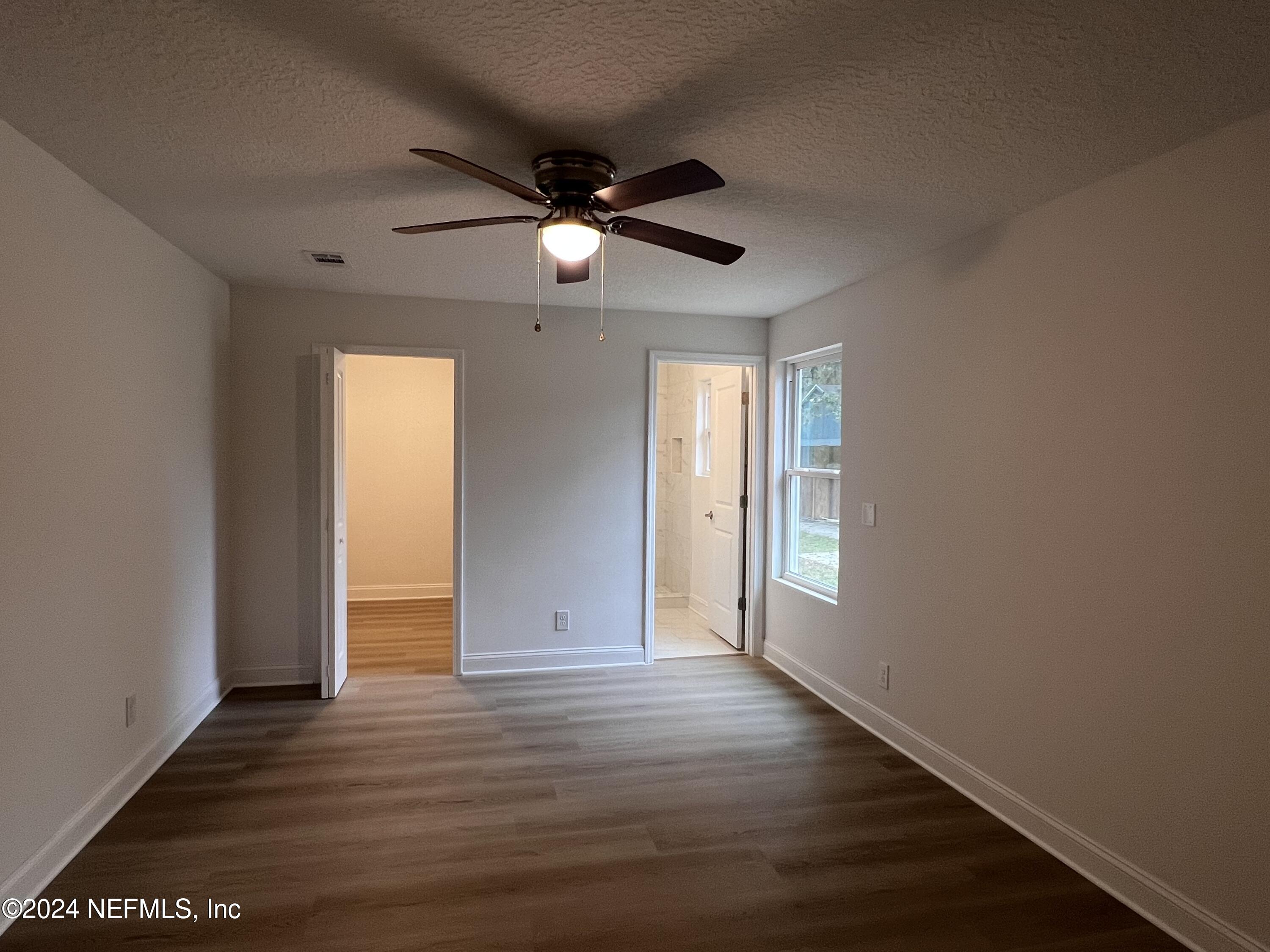 1833 Bartram Road Jacksonville, FL 32207 - Photo 15 of 50 an empty room with wooden floor and windows