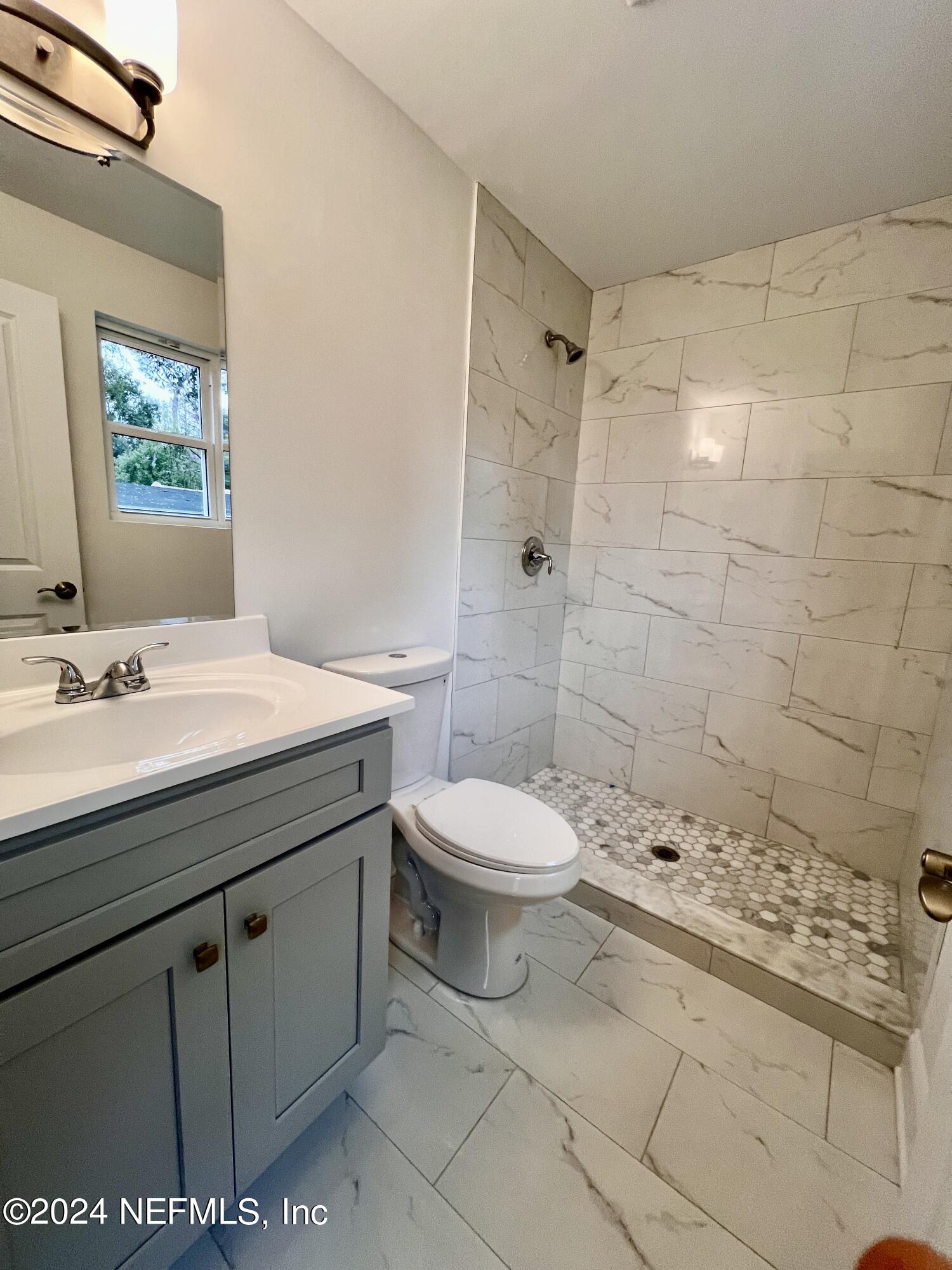 1833 Bartram Road Jacksonville, FL 32207 - Photo 17 of 50 a bathroom with a sink a toilet and shower