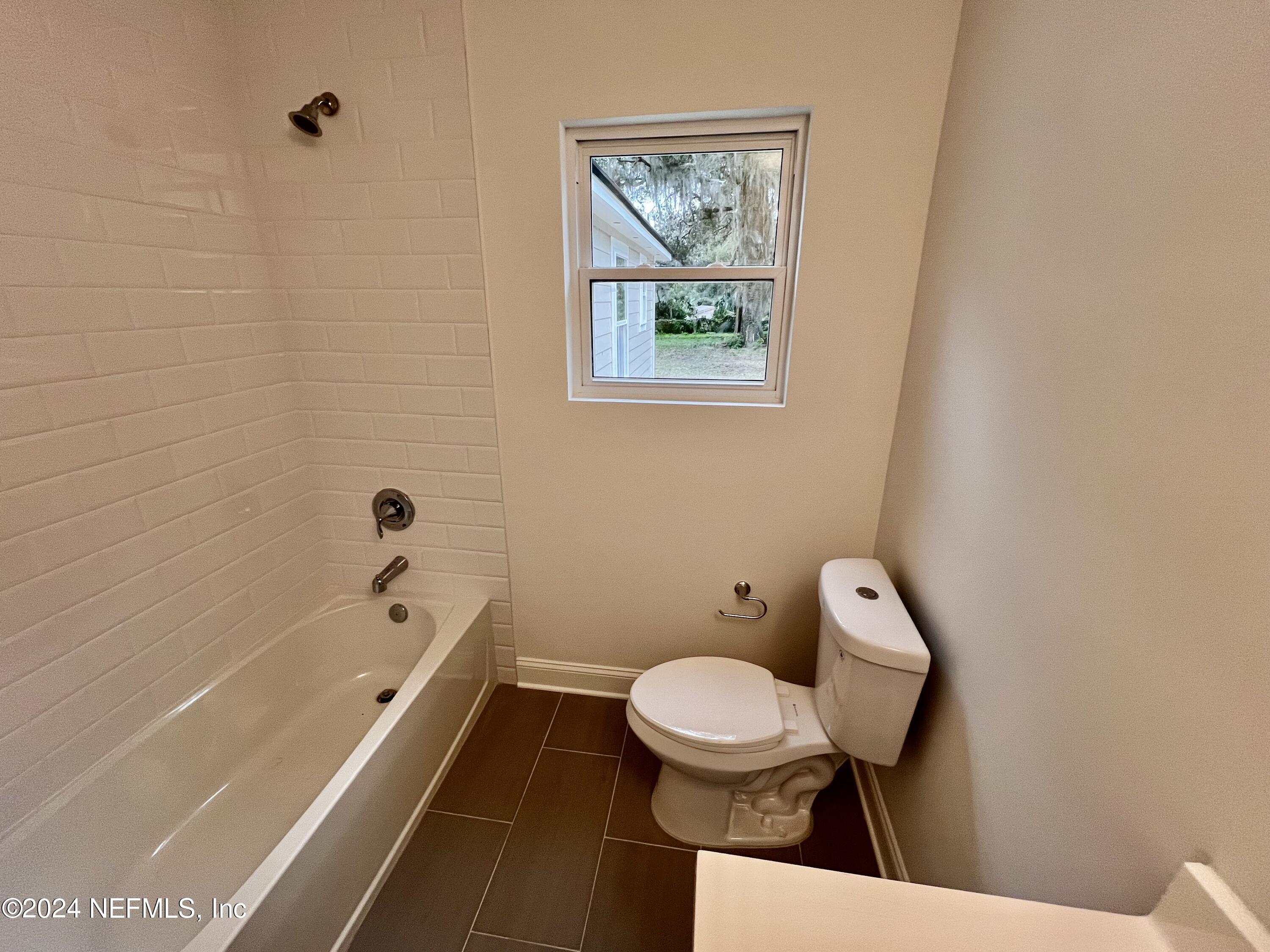 1833 Bartram Road Jacksonville, FL 32207 - Photo 23 of 50 a bathroom with a toilet a sink and bathtub